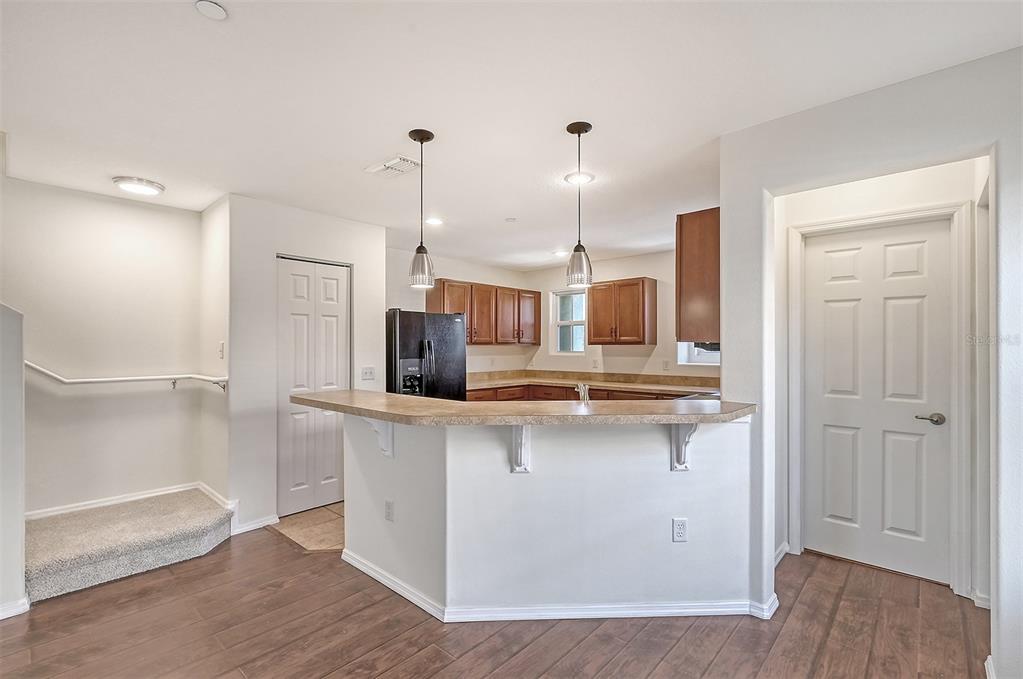 8922 White Sage Loop Lakewood Ranch, FL 34202 - Photo 13 of 65 a kitchen with stainless steel appliances a sink and wooden floors