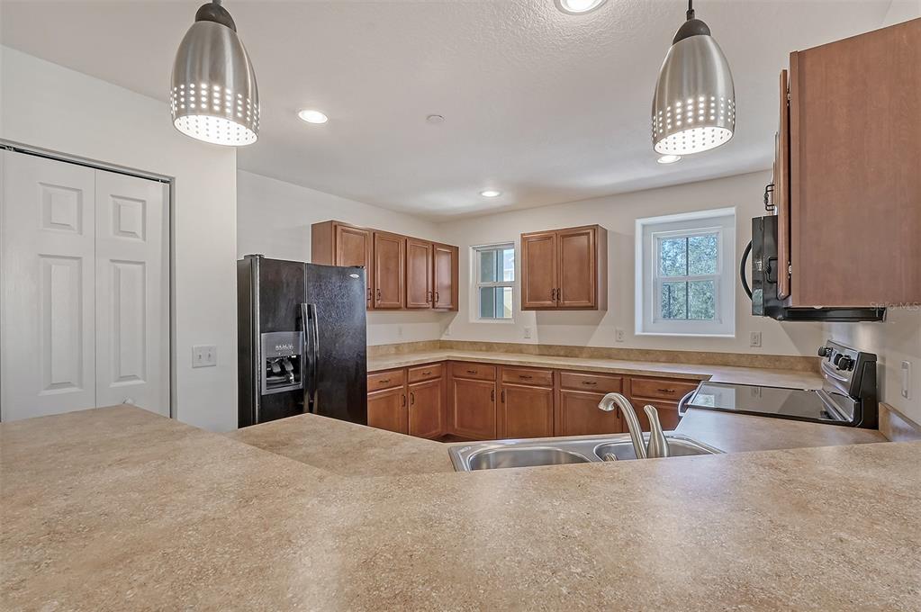 8922 White Sage Loop Lakewood Ranch, FL 34202 - Photo 14 of 65 a kitchen with stainless steel appliances granite countertop a refrigerator and a sink