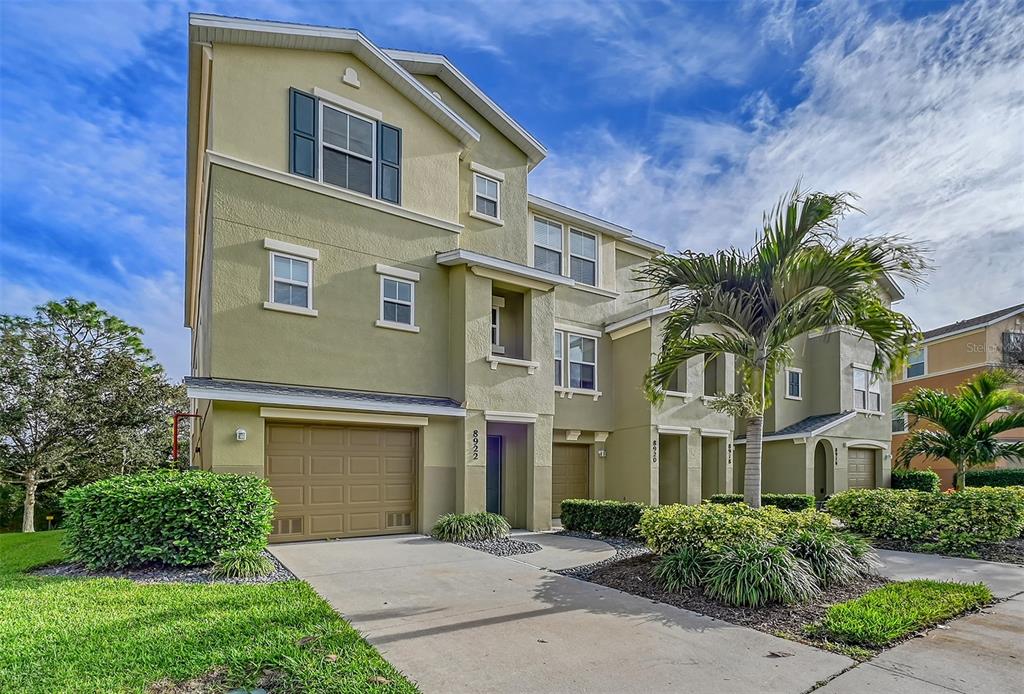 8922 White Sage Loop Lakewood Ranch, FL 34202 - Photo 2 of 65 a front view of a house with a garden