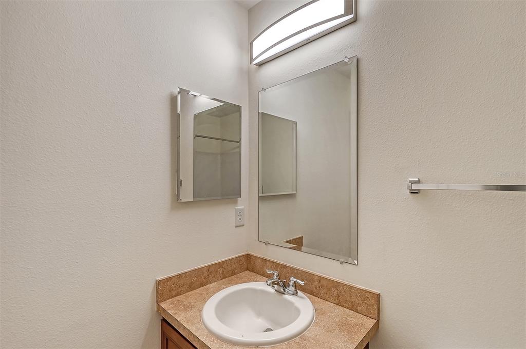 8922 White Sage Loop Lakewood Ranch, FL 34202 - Photo 33 of 65 a bathroom with a sink and a mirror