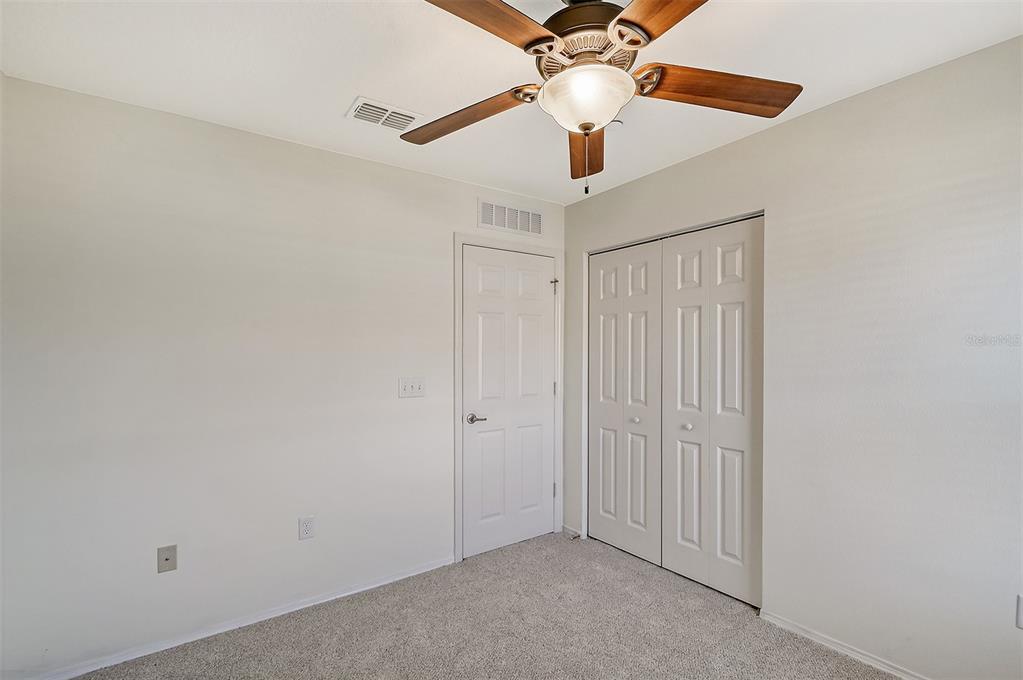 8922 White Sage Loop Lakewood Ranch, FL 34202 - Photo 36 of 65 an empty room with a ceiling fan and a fan