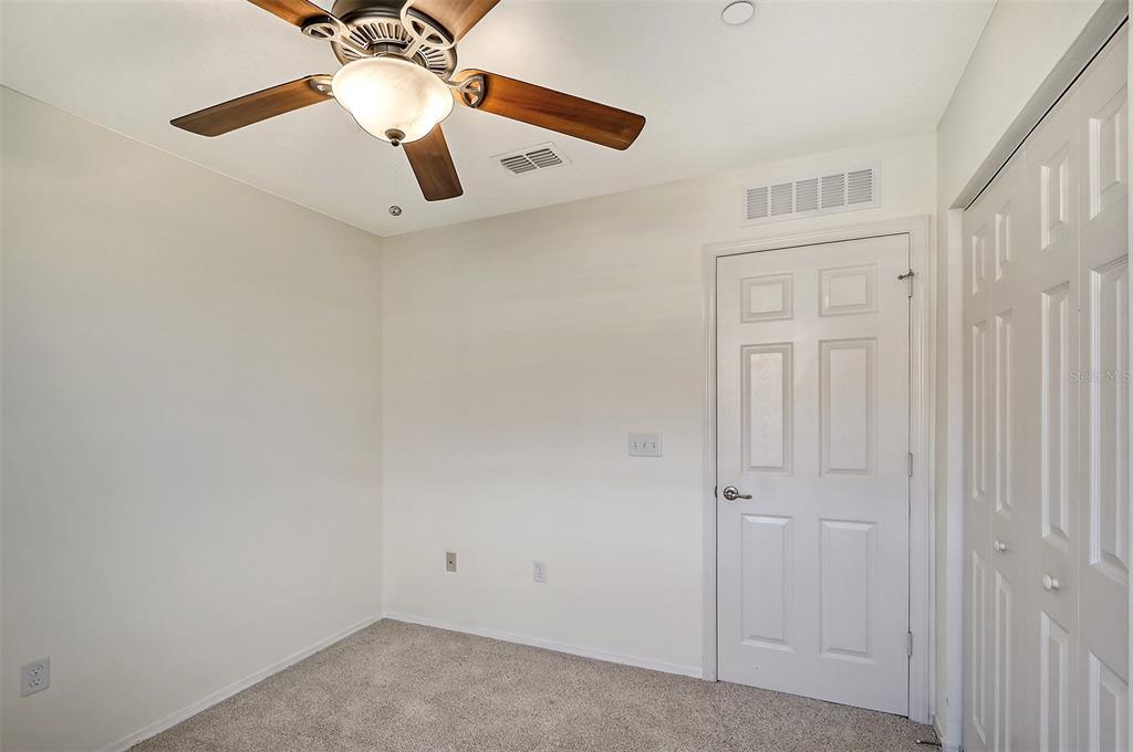8922 White Sage Loop Lakewood Ranch, FL 34202 - Photo 37 of 65 en empty room with a chandelier fan