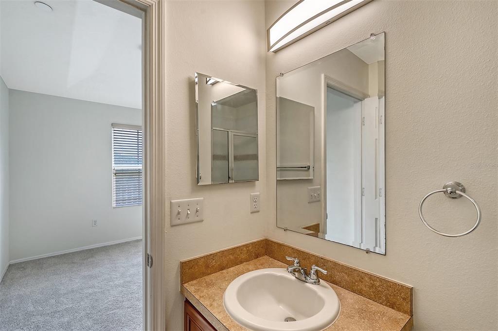 8922 White Sage Loop Lakewood Ranch, FL 34202 - Photo 43 of 65 a bathroom with a sink and a mirror