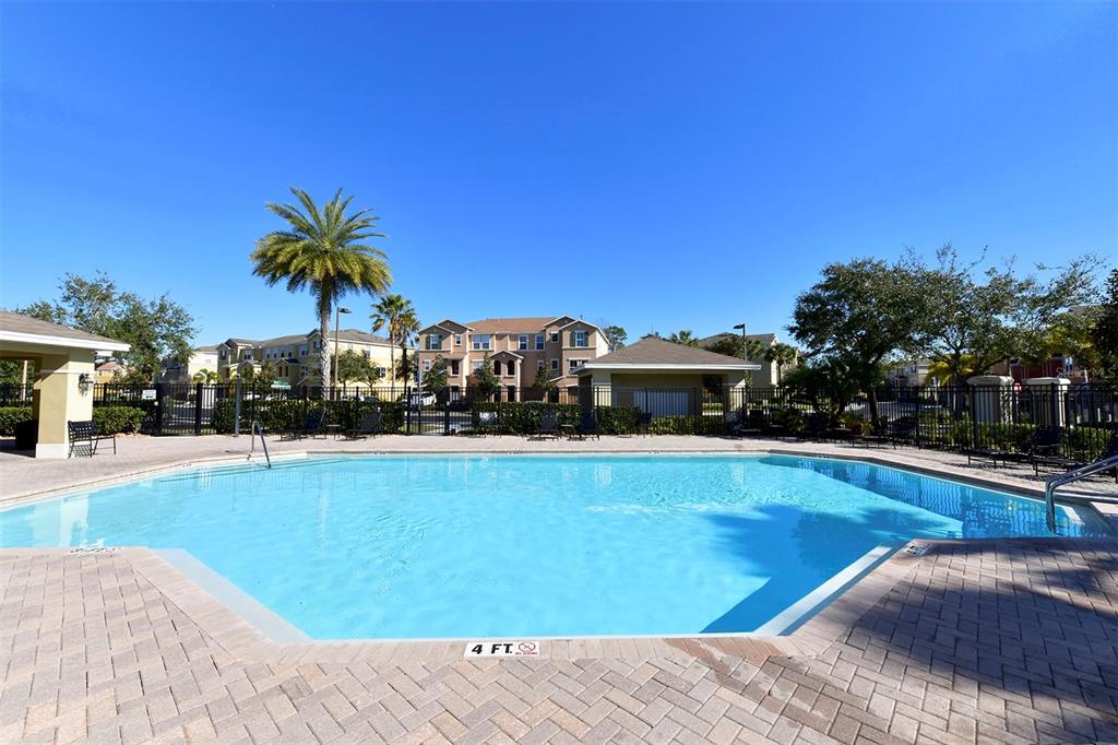 8922 White Sage Loop Lakewood Ranch, FL 34202 - Photo 57 of 65 a view of a swimming pool with a lawn chairs under an umbrella