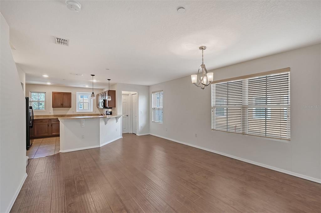 8922 White Sage Loop Lakewood Ranch, FL 34202 - Photo 8 of 65 a view of a kitchen with a sink wooden floor and a kitchen