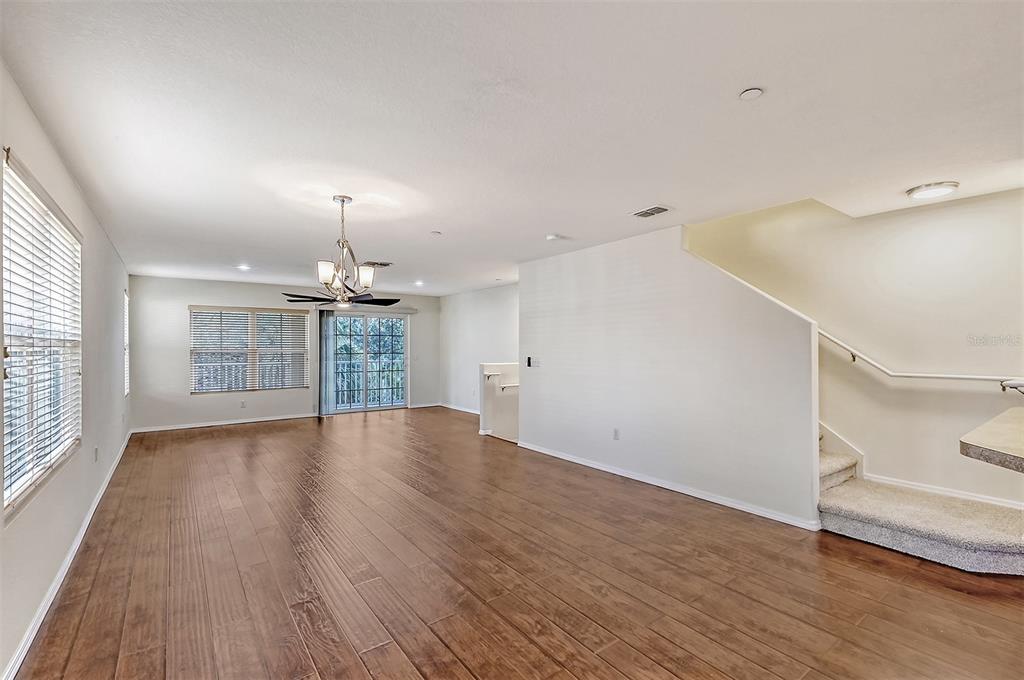 8922 White Sage Loop Lakewood Ranch, FL 34202 - Photo 9 of 65 an empty room with wooden floor and windows