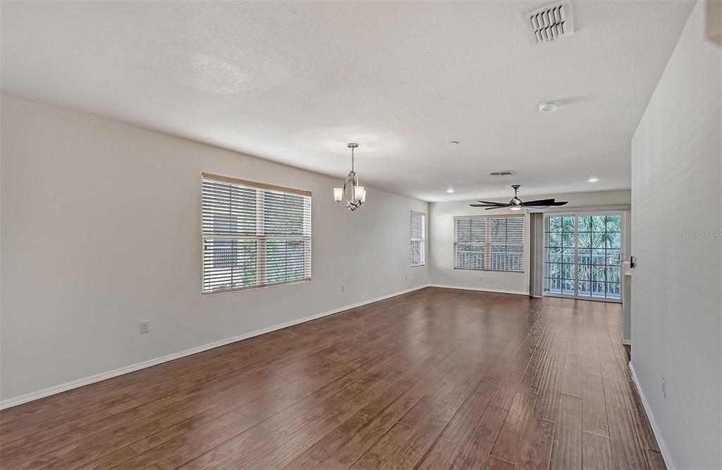 8922 White Sage Loop Lakewood Ranch, FL 34202 - Photo 10 of 65 wooden floor in an empty room with a window