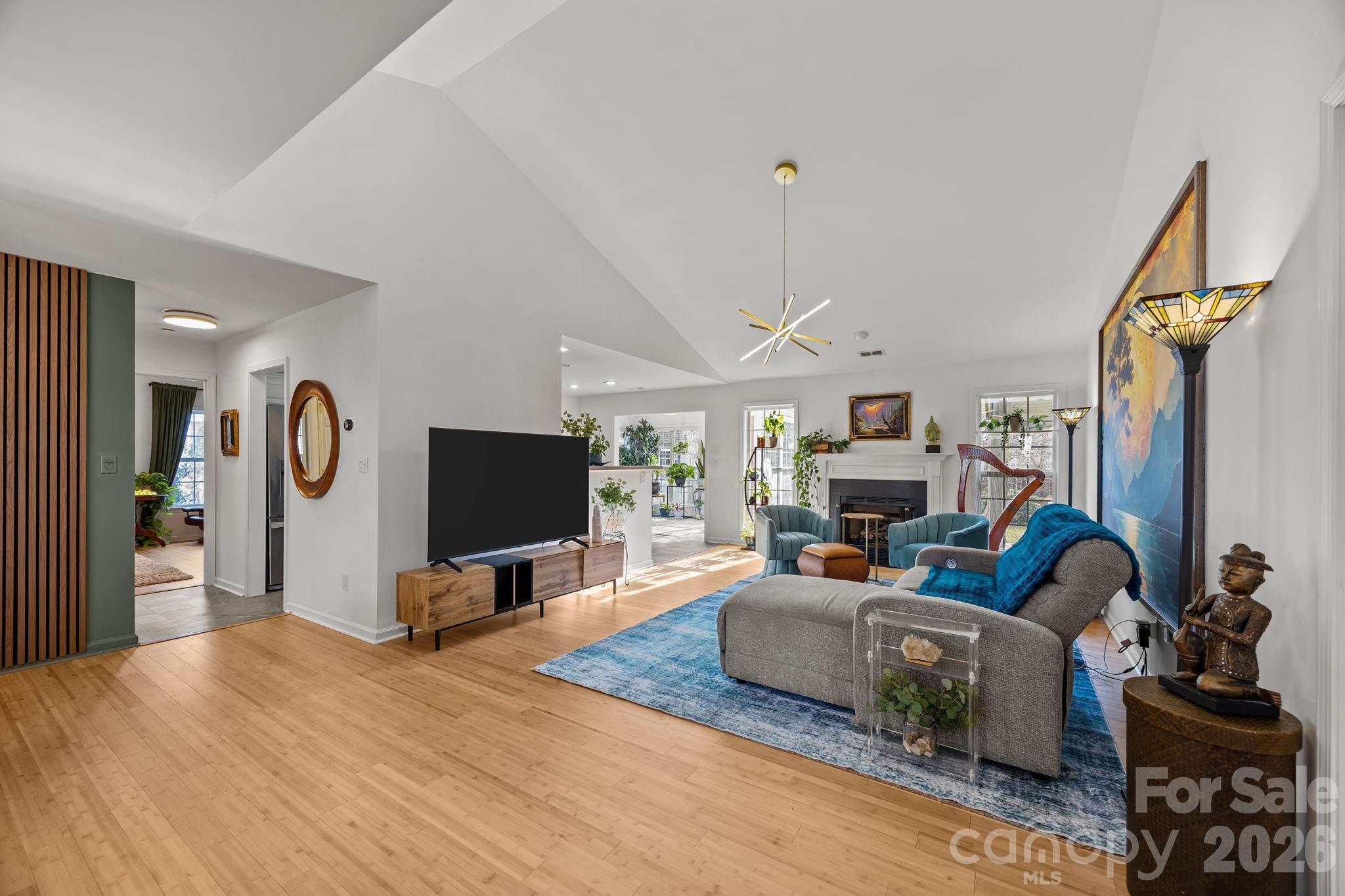 244 Running Briar Road Fletcher, NC 28732 - Photo 11 of 45 a living room with furniture a mirror and a flat screen tv