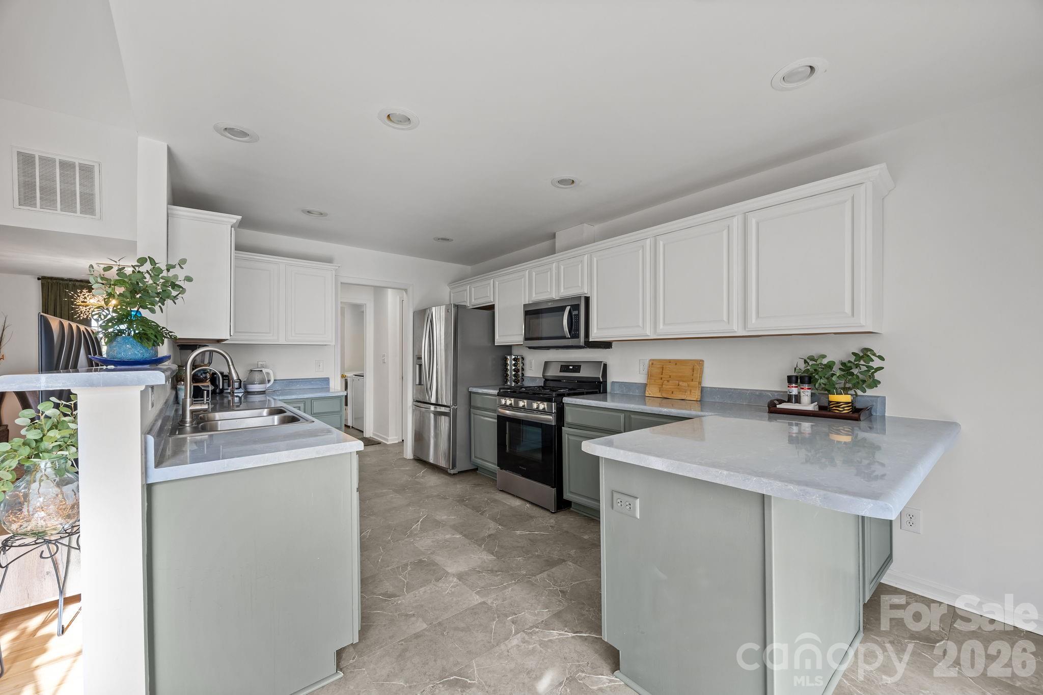 244 Running Briar Road Fletcher, NC 28732 - Photo 14 of 45 a kitchen with a sink stove top oven and refrigerator