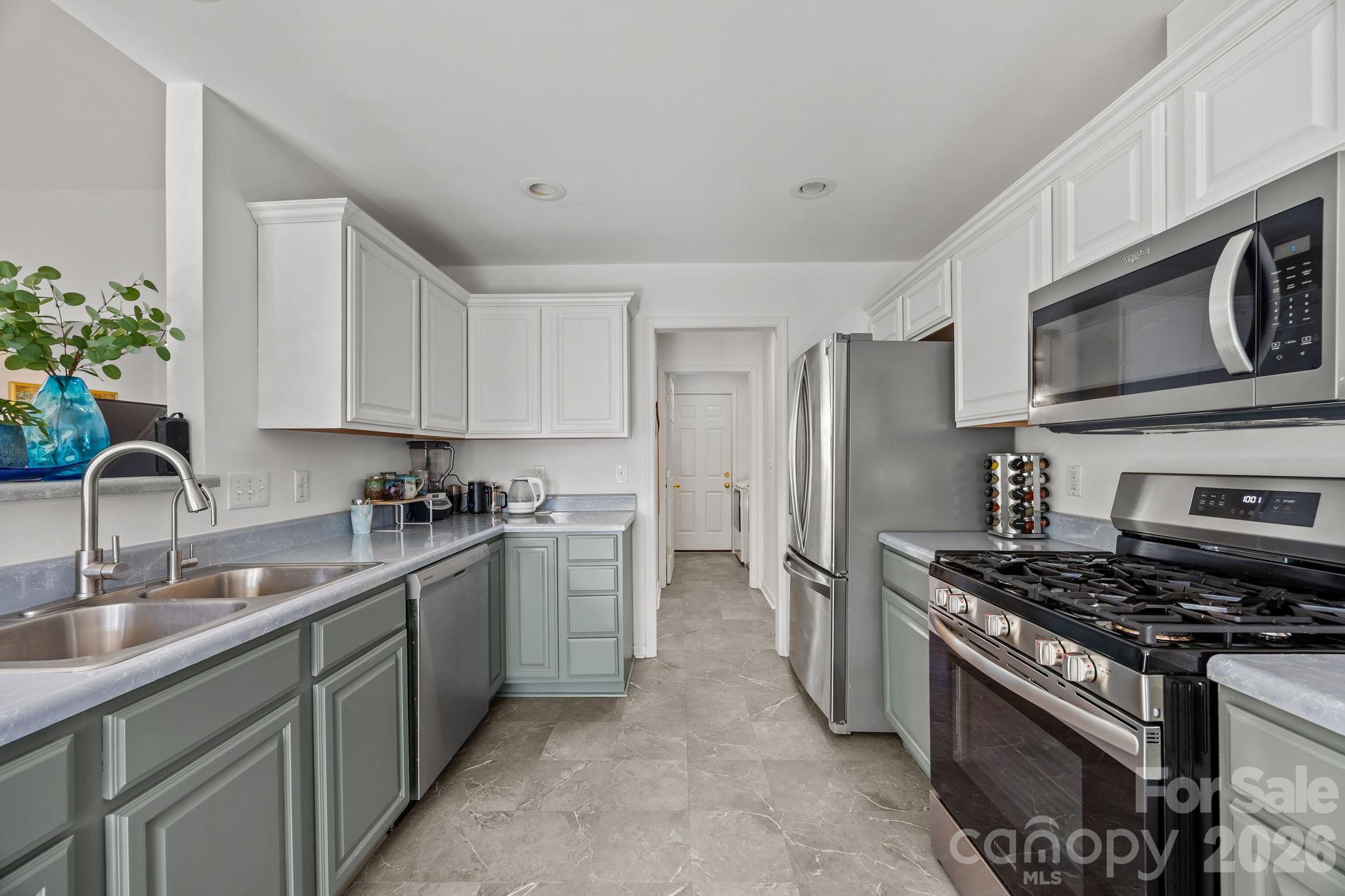 244 Running Briar Road Fletcher, NC 28732 - Photo 15 of 45 a kitchen with stainless steel appliances granite countertop a sink stove and refrigerator