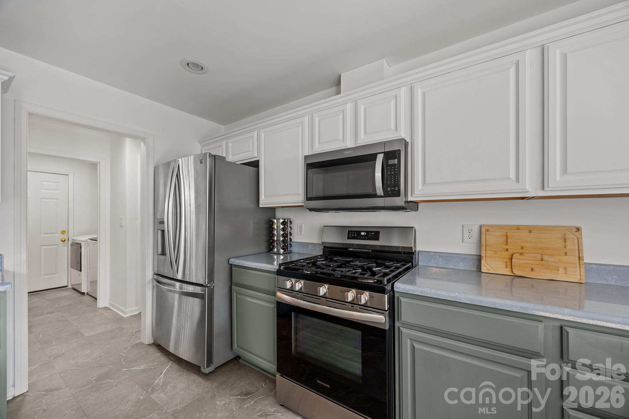244 Running Briar Road Fletcher, NC 28732 - Photo 17 of 45 a kitchen with stainless steel appliances a refrigerator stove and microwave