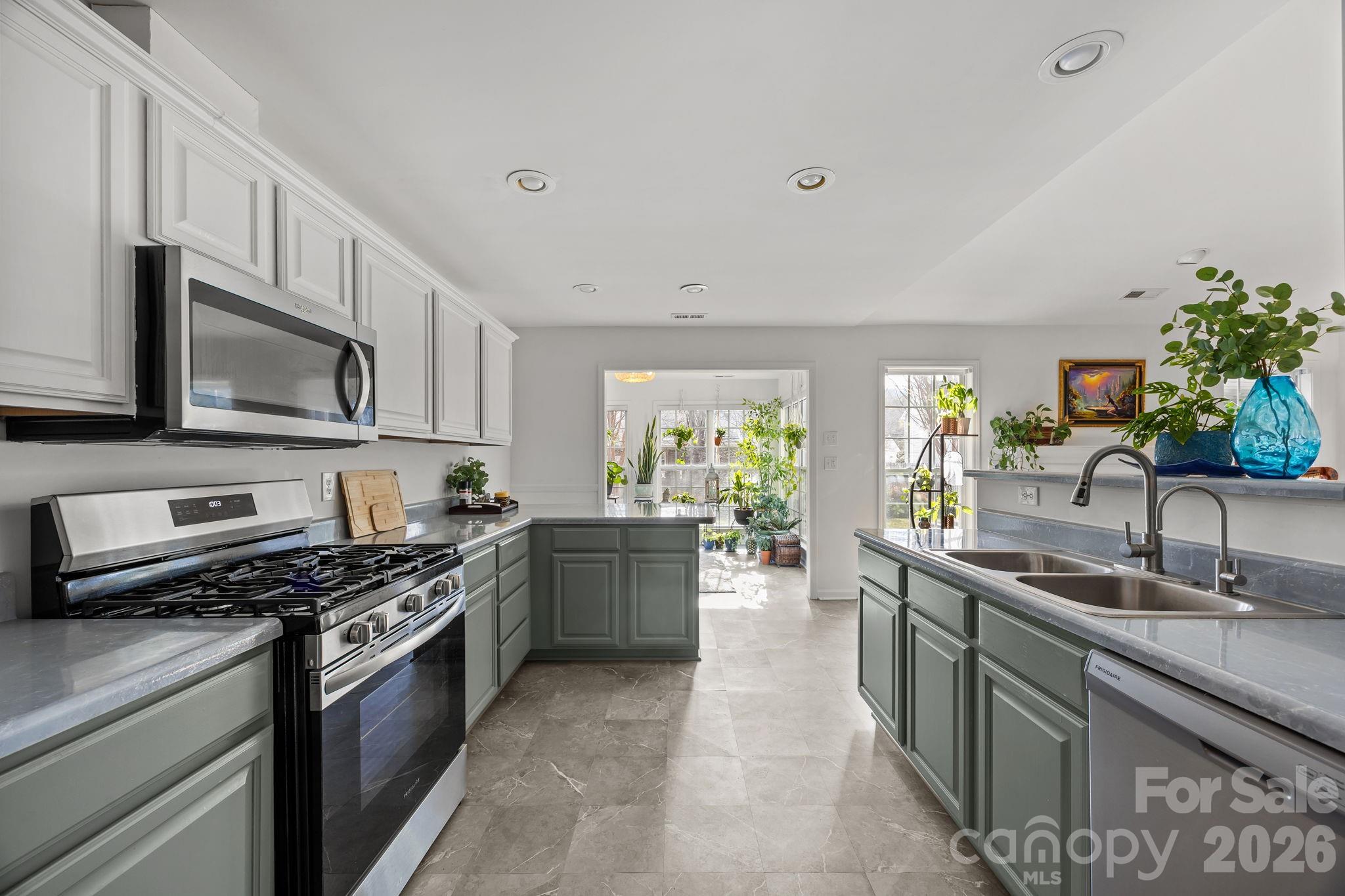 244 Running Briar Road Fletcher, NC 28732 - Photo 18 of 45 a kitchen with stainless steel appliances granite countertop a sink stove and microwave