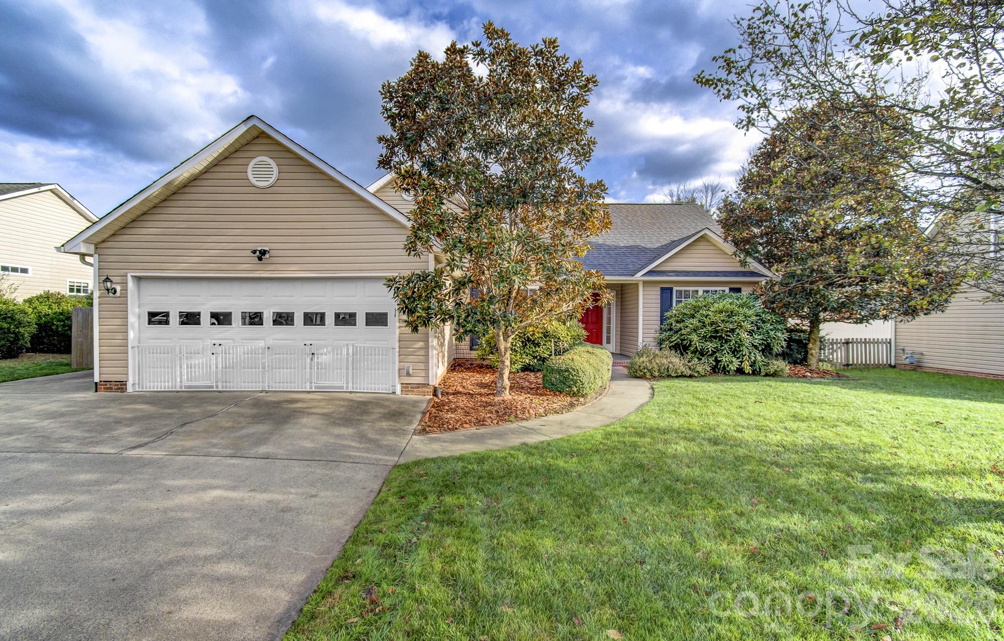 244 Running Briar Road Fletcher, NC 28732 - Photo 2 of 45 a front view of a house with a yard and garage