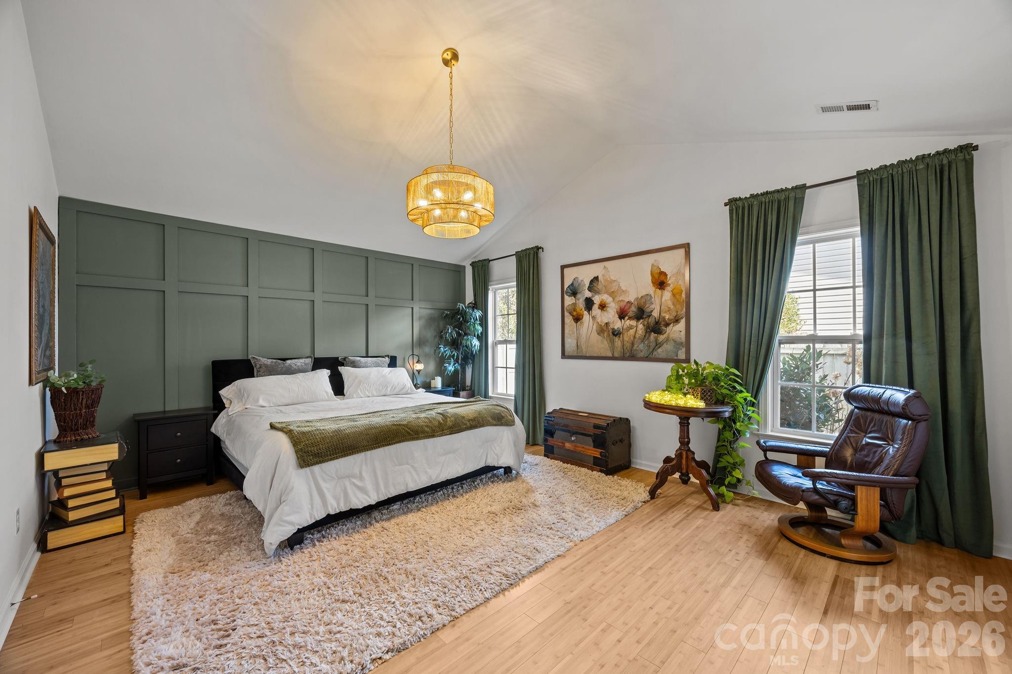 244 Running Briar Road Fletcher, NC 28732 - Photo 21 of 45 a spacious bedroom with a bed and a chandelier