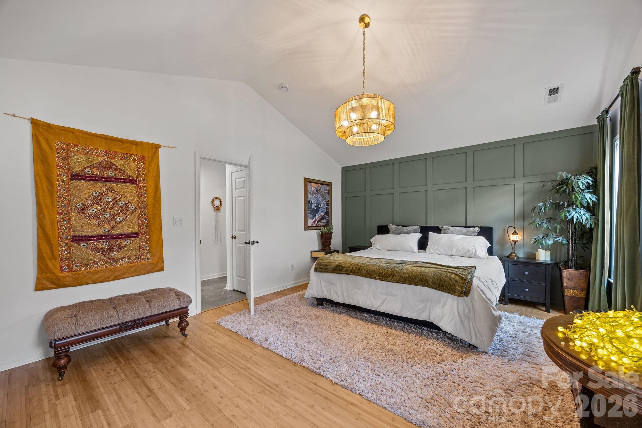 244 Running Briar Road Fletcher, NC 28732 - Photo 22 of 45 a spacious bedroom with a bed and a chandelier