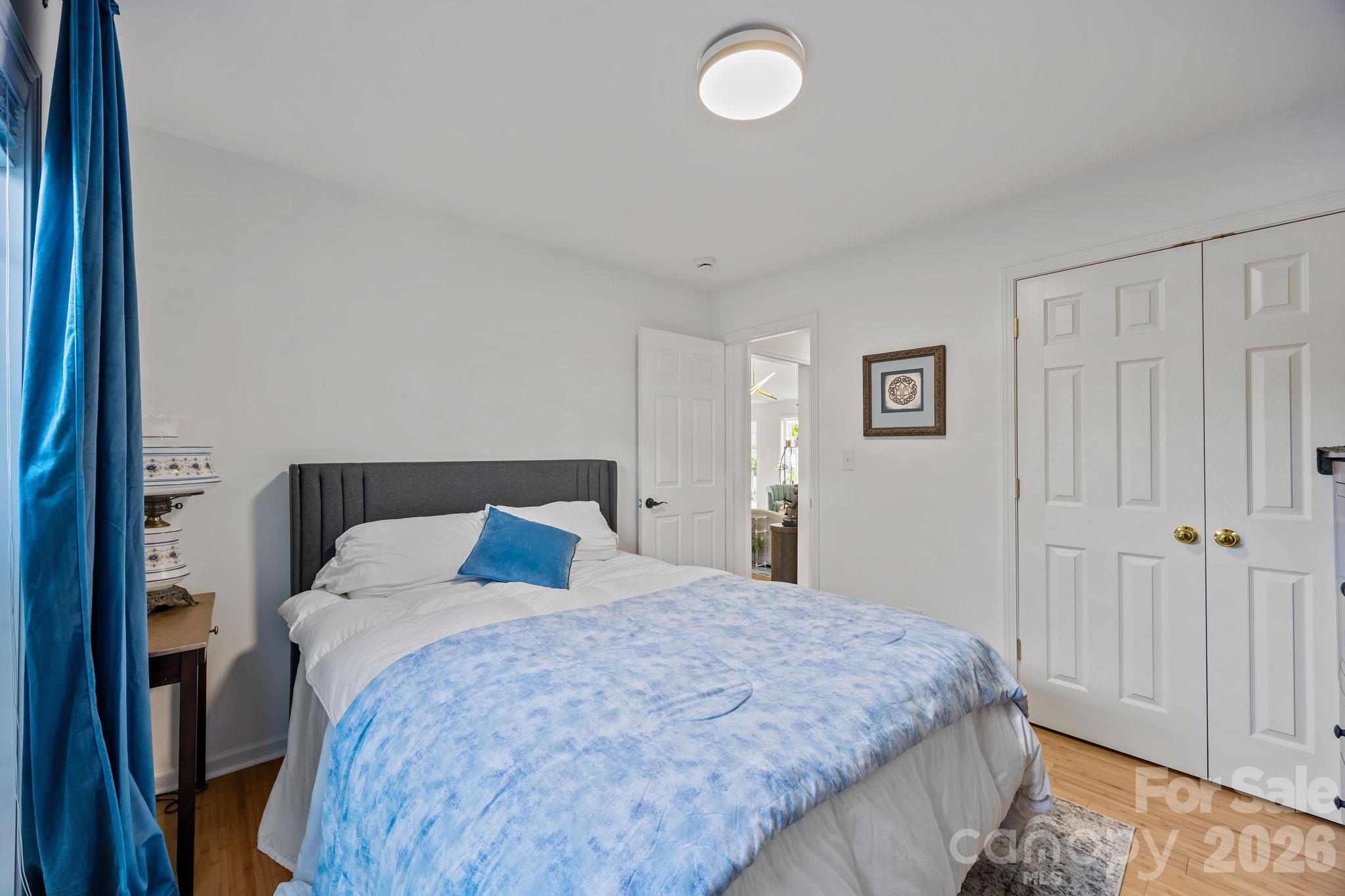 244 Running Briar Road Fletcher, NC 28732 - Photo 28 of 45 a bedroom with a bed and a painting on the wall