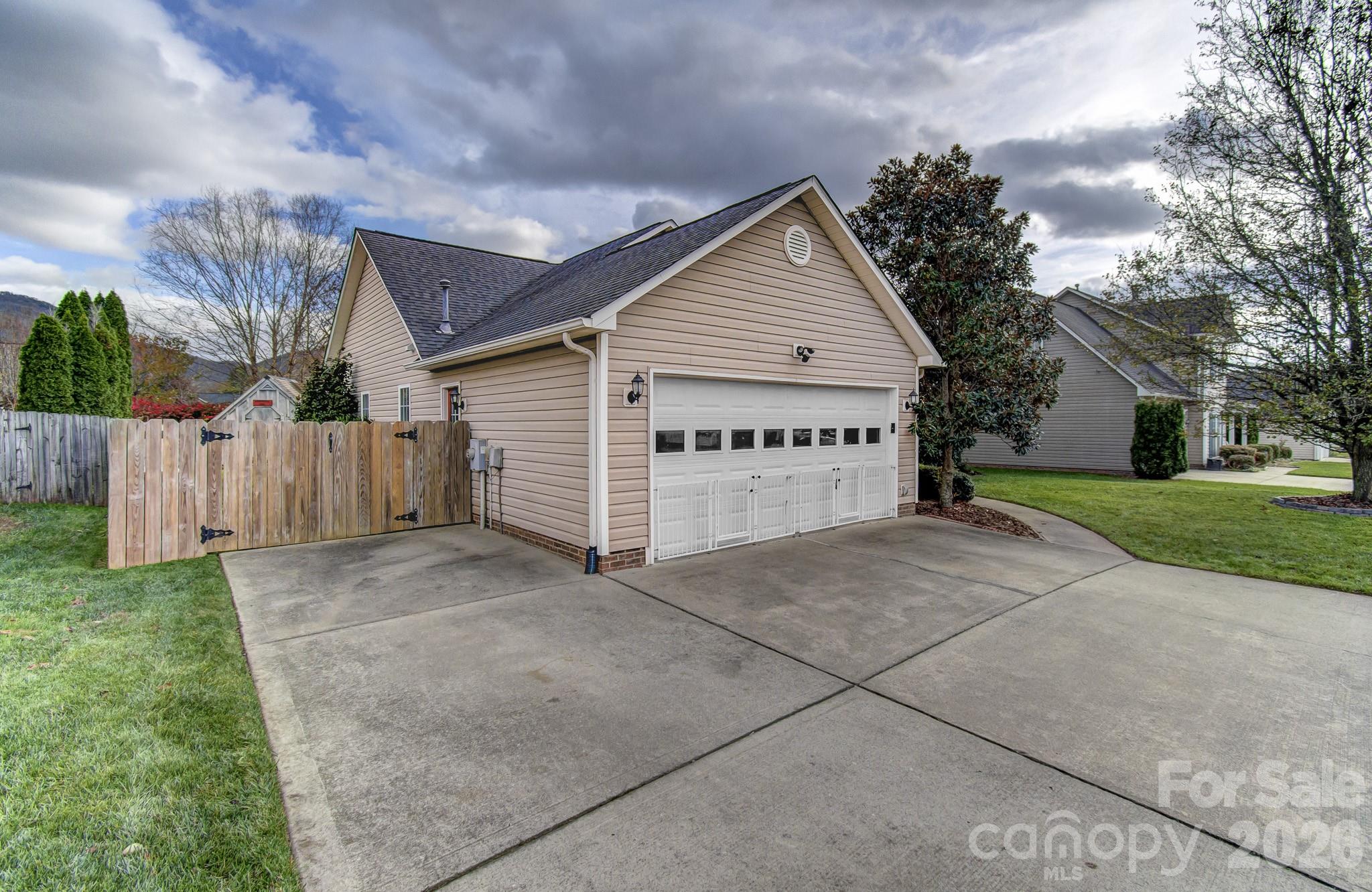 244 Running Briar Road Fletcher, NC 28732 - Photo 3 of 45 a view of a house with a yard and garage