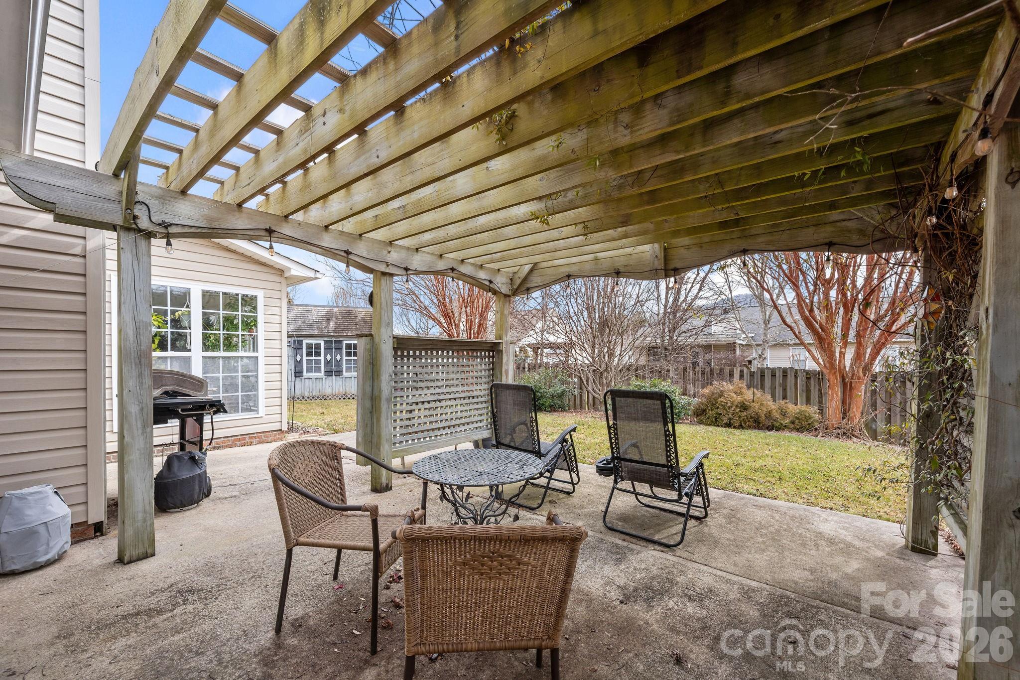 244 Running Briar Road Fletcher, NC 28732 - Photo 39 of 45 a view of a patio with table and chairs with wooden floor and fence