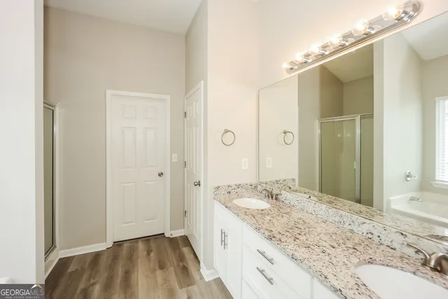 a bathroom with a granite countertop sink and a mirror