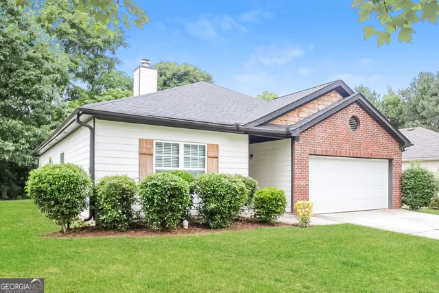 a front view of a house with a garden