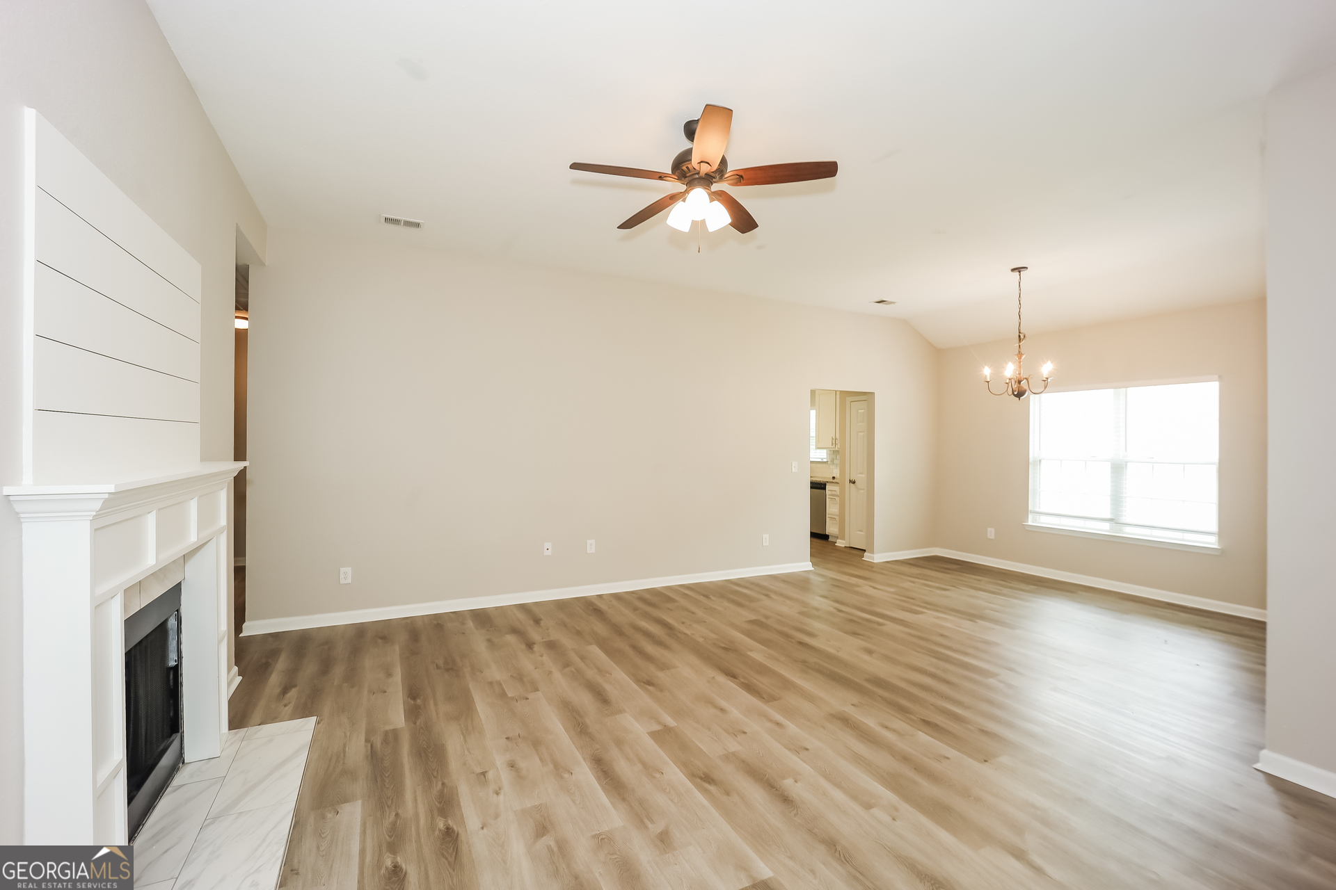 5517 Jerome Road South Fulton, GA 30349 - Photo 3 of 16 a view of empty room with wooden floor and fireplace
