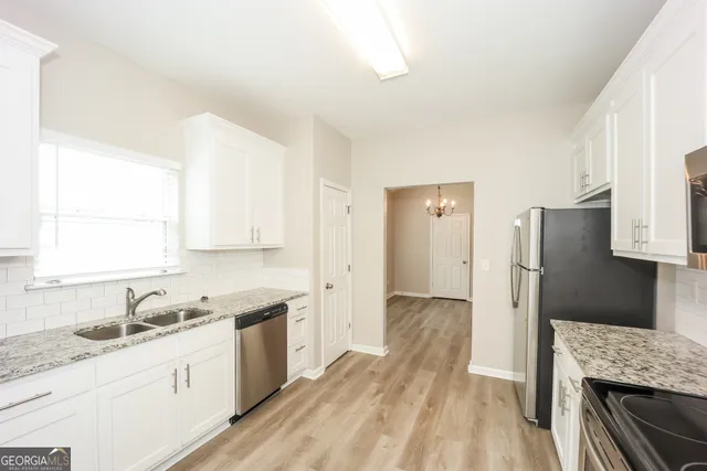 a kitchen with a sink stove and refrigerator