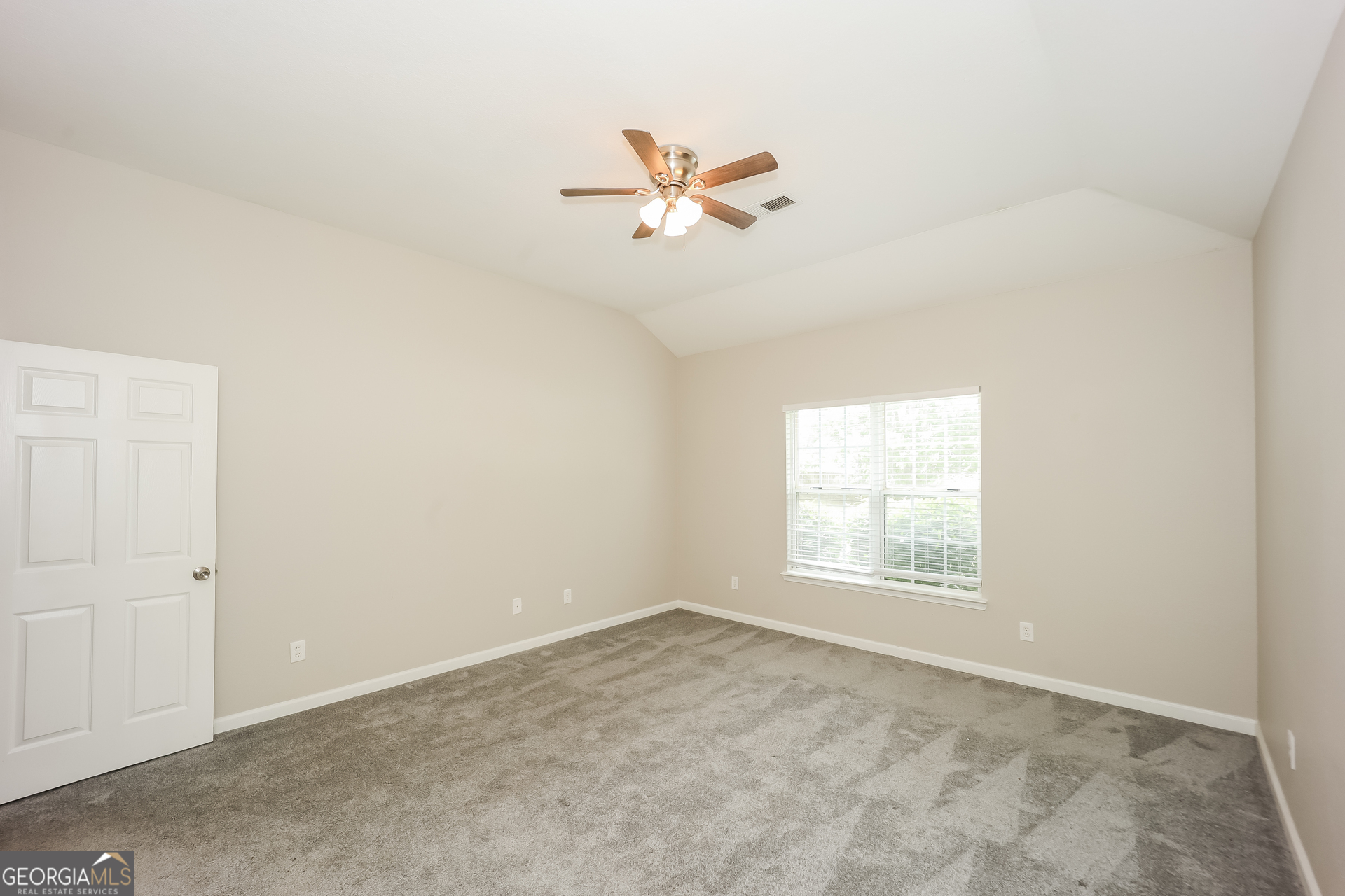 5517 Jerome Road South Fulton, GA 30349 - Photo 8 of 16 an empty room with windows and fan