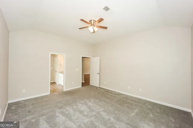 a view of a livingroom with a ceiling fan and window
