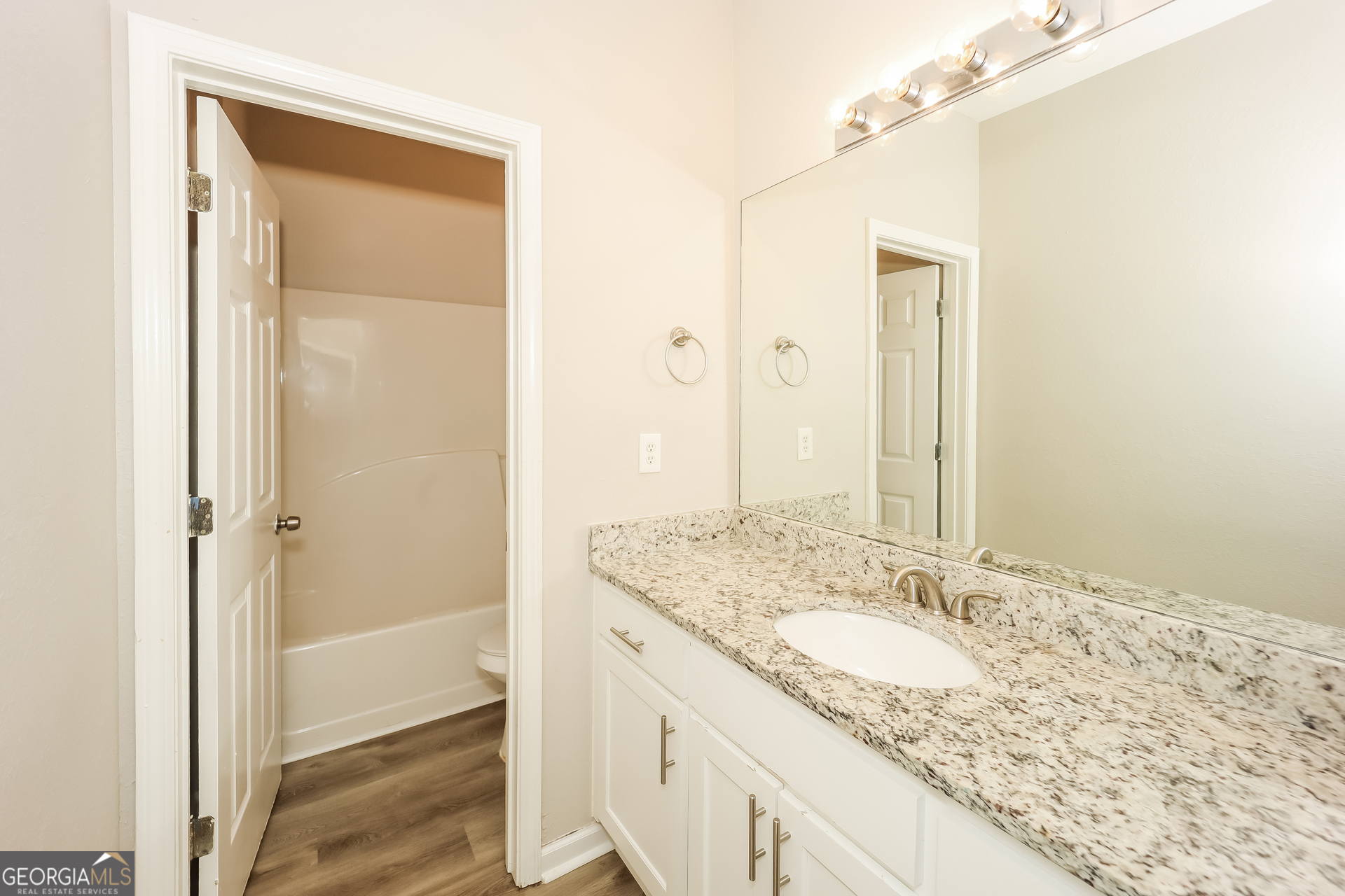 5517 Jerome Road South Fulton, GA 30349 - Photo 10 of 16 a bathroom with a granite countertop sink and a mirror