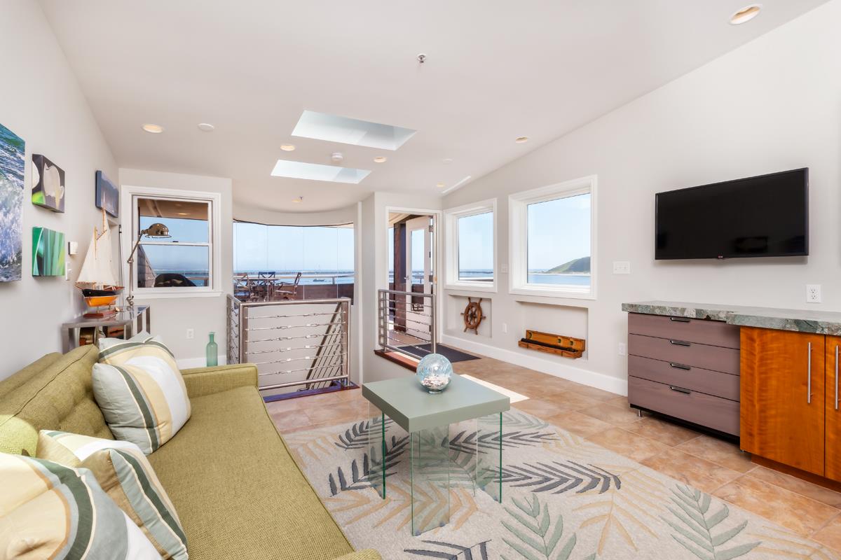 123 Ocean Boulevard Half Moon Bay, CA 94019 - Photo 12 of 30 a living room with furniture and a flat screen tv
