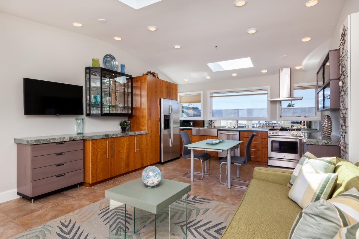 123 Ocean Boulevard Half Moon Bay, CA 94019 - Photo 13 of 30 a living room with stainless steel appliances furniture and a flat screen tv