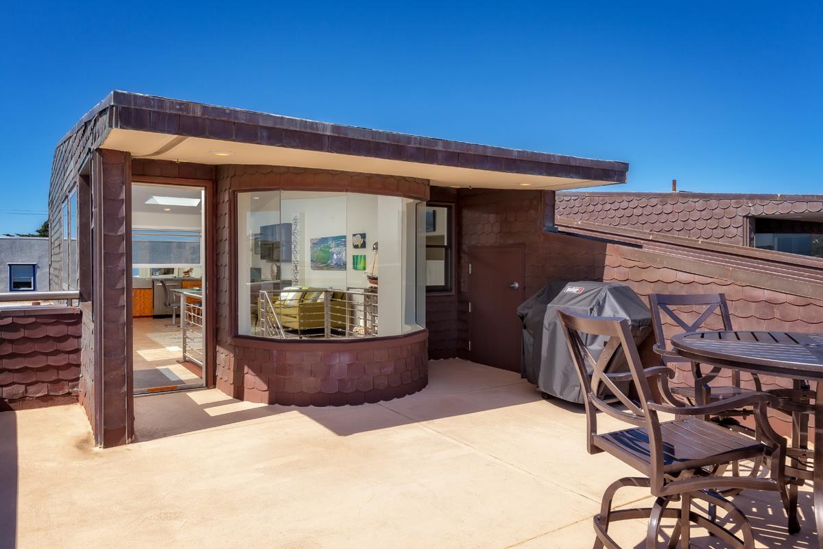 123 Ocean Boulevard Half Moon Bay, CA 94019 - Photo 14 of 30 a view of a patio with table and chairs