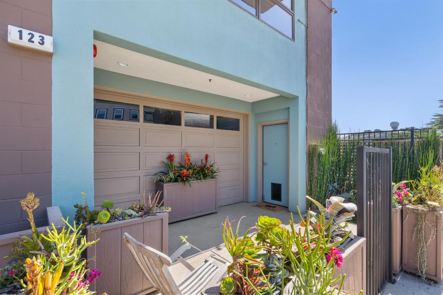 123 Ocean Boulevard Half Moon Bay, CA 94019 - Photo 21 of 30 a potted plant sitting in front of a house