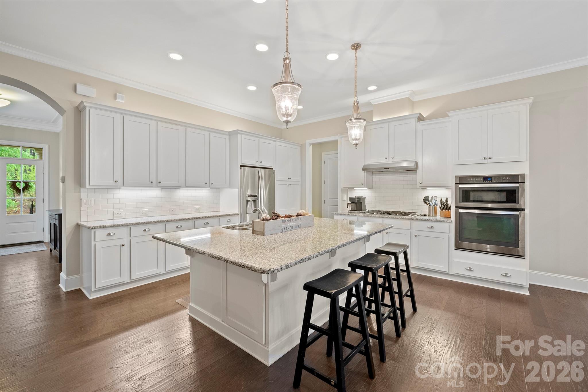 13044 Fen Court Huntersville, NC 28078 - Photo 12 of 43 a kitchen with stainless steel appliances granite countertop a white cabinets and wooden floor