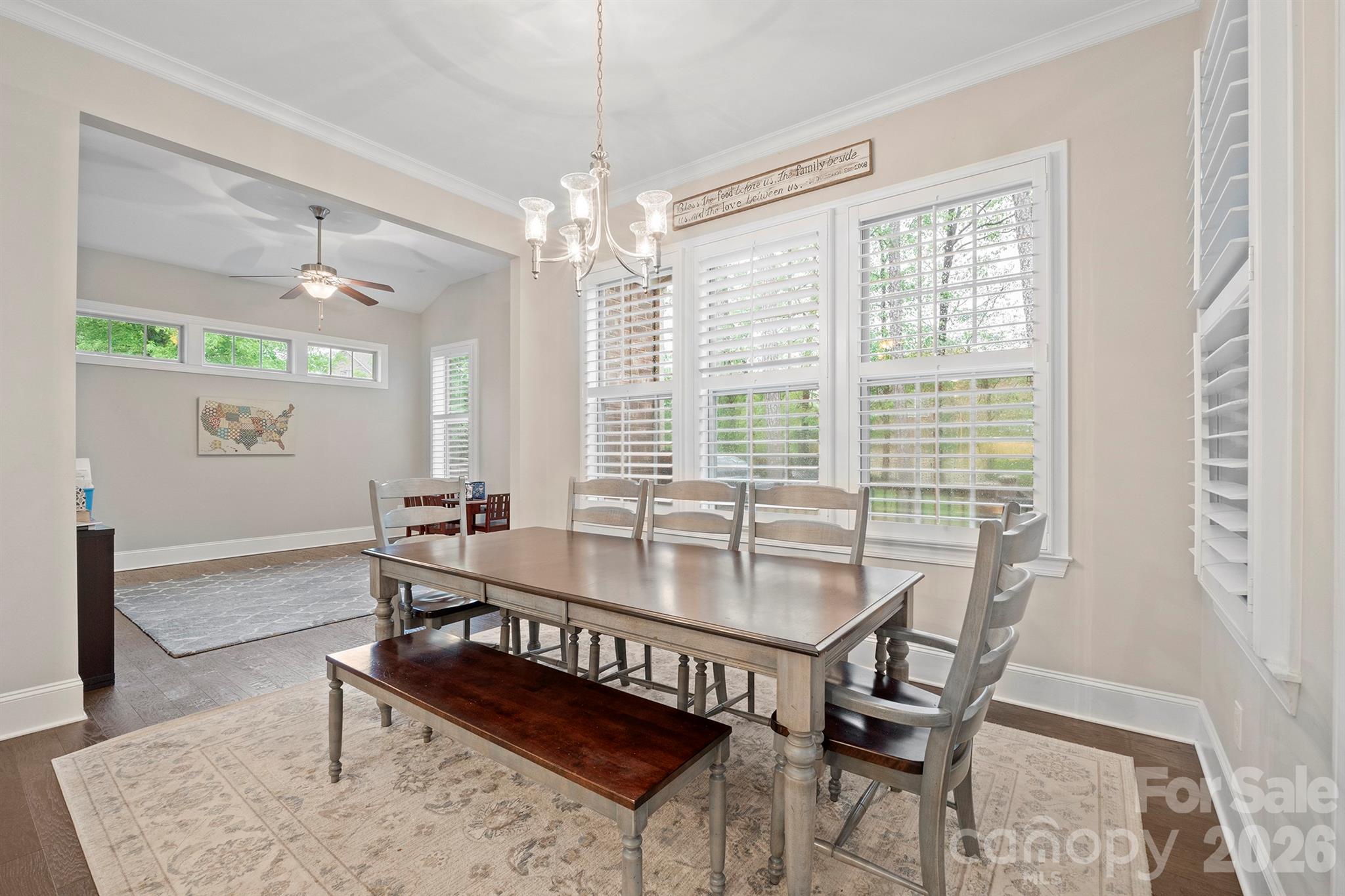 13044 Fen Court Huntersville, NC 28078 - Photo 16 of 43 a dining room with furniture a chandelier and wooden floor