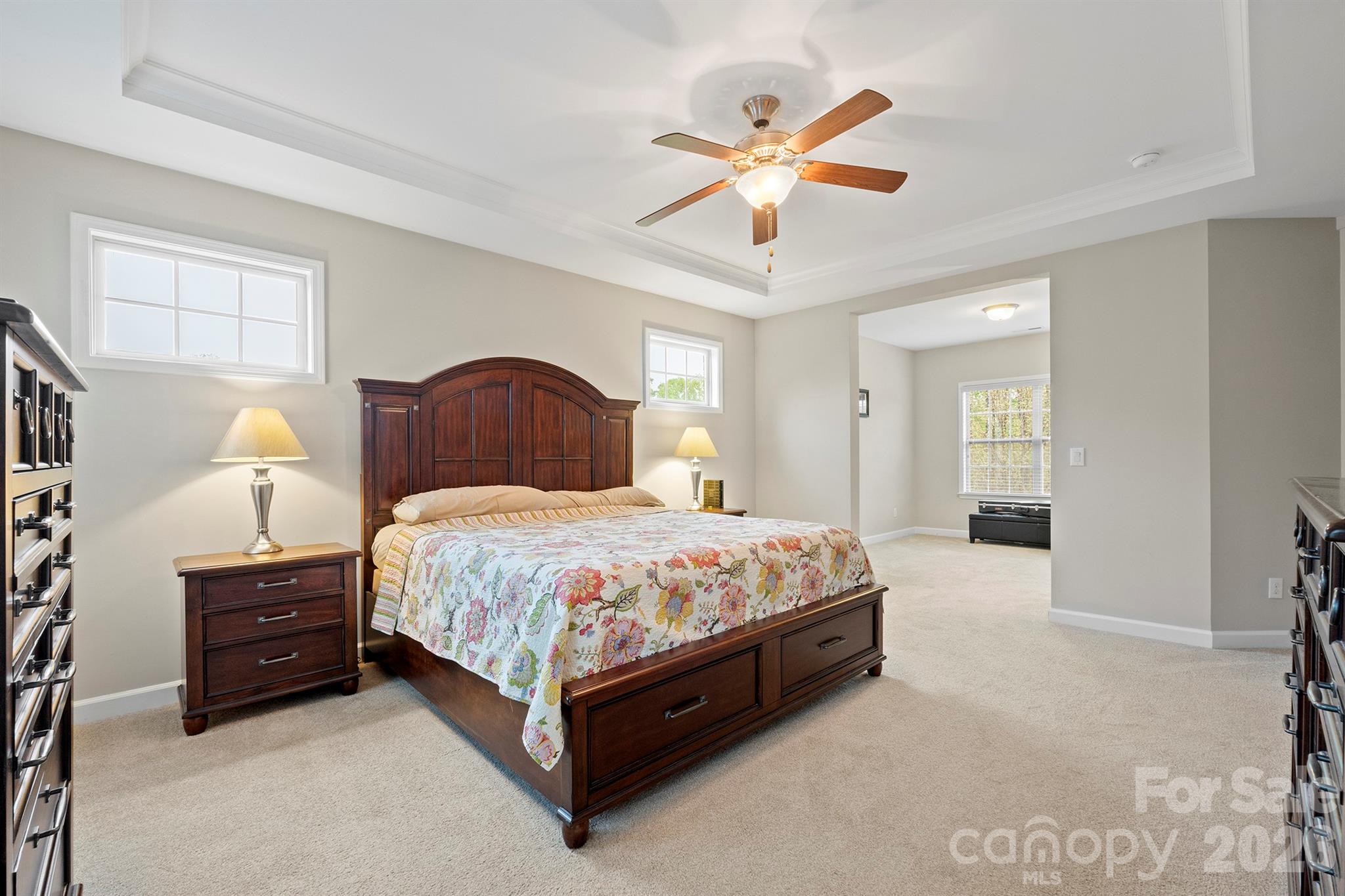 13044 Fen Court Huntersville, NC 28078 - Photo 23 of 43 a spacious bedroom with a bed and a chandelier
