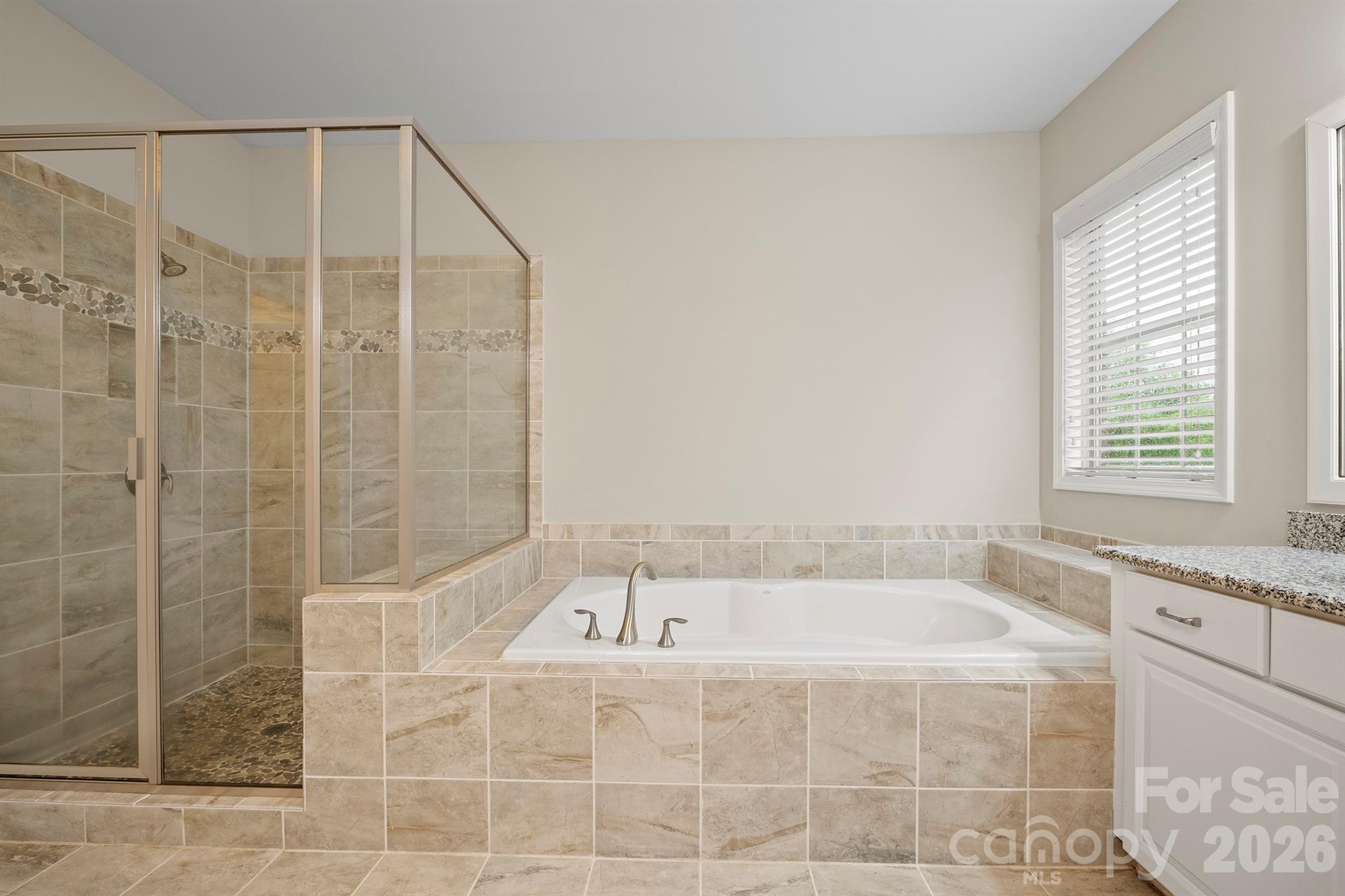 13044 Fen Court Huntersville, NC 28078 - Photo 26 of 43 a bathroom with a bathtub and shower