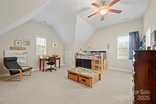 a living room with furniture and a dining table with projector