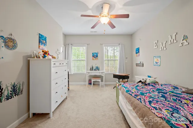 a bedroom with furniture and a chandelier