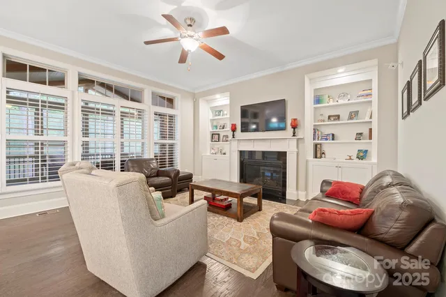 a living room with furniture fireplace and a flat screen tv
