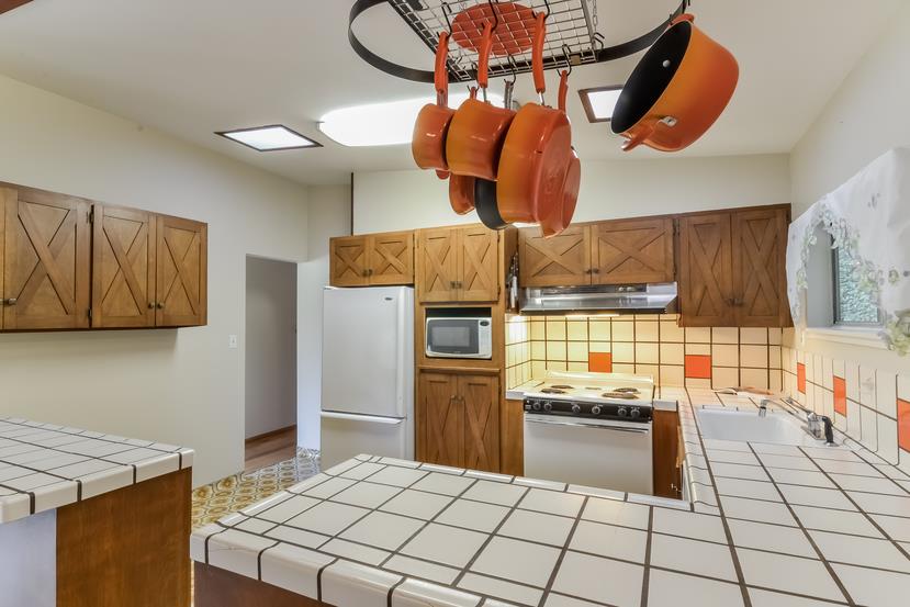 712 Ursula Avenue Pacifica, CA 94044 - Photo 13 of 42 a kitchen with stainless steel appliances granite countertop a stove a sink and a refrigerator
