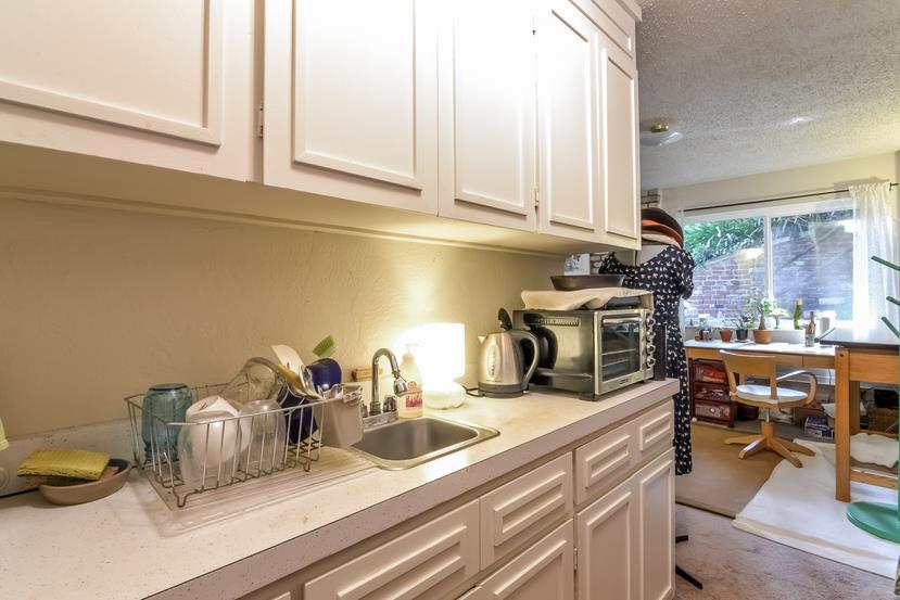 712 Ursula Avenue Pacifica, CA 94044 - Photo 24 of 42 a kitchen with a sink and cabinets