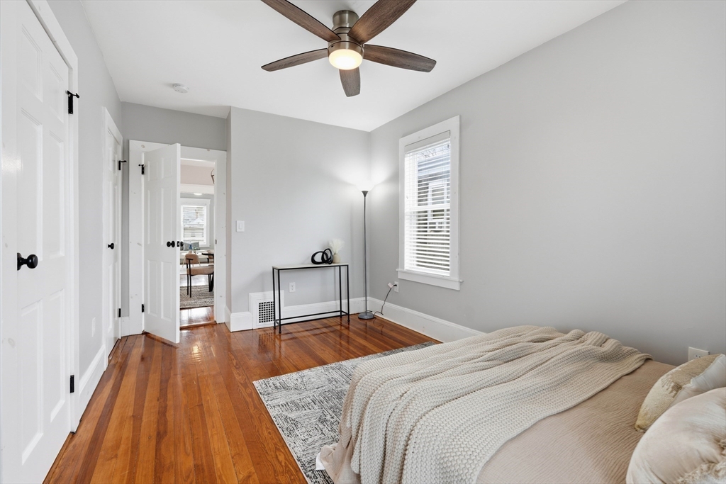 20 Ripley Road, Unit 3 Boston, MA 02121 - Photo 13 of 27 a bedroom with a bed and a chandelier