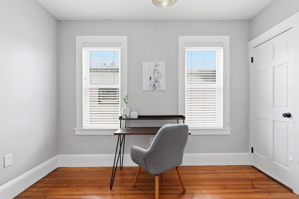 20 Ripley Road, Unit 3 Boston, MA 02121 - Photo 16 of 27 a view of a workspace room with wooden floor and windows