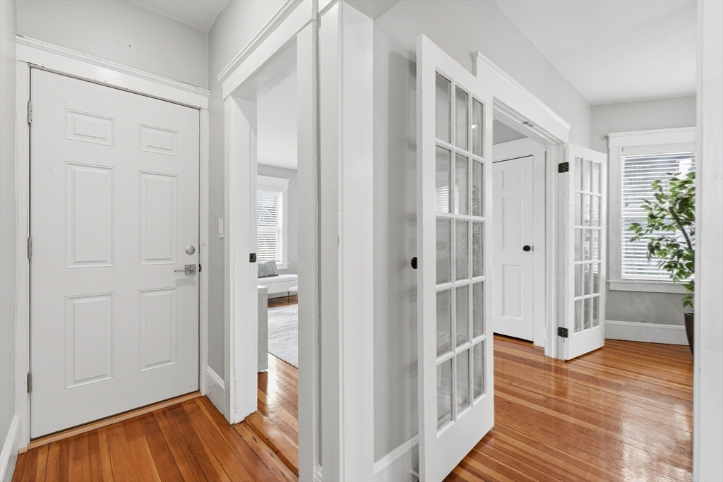 20 Ripley Road, Unit 3 Boston, MA 02121 - Photo 17 of 27 a view of a hallway with wooden floor and staircase