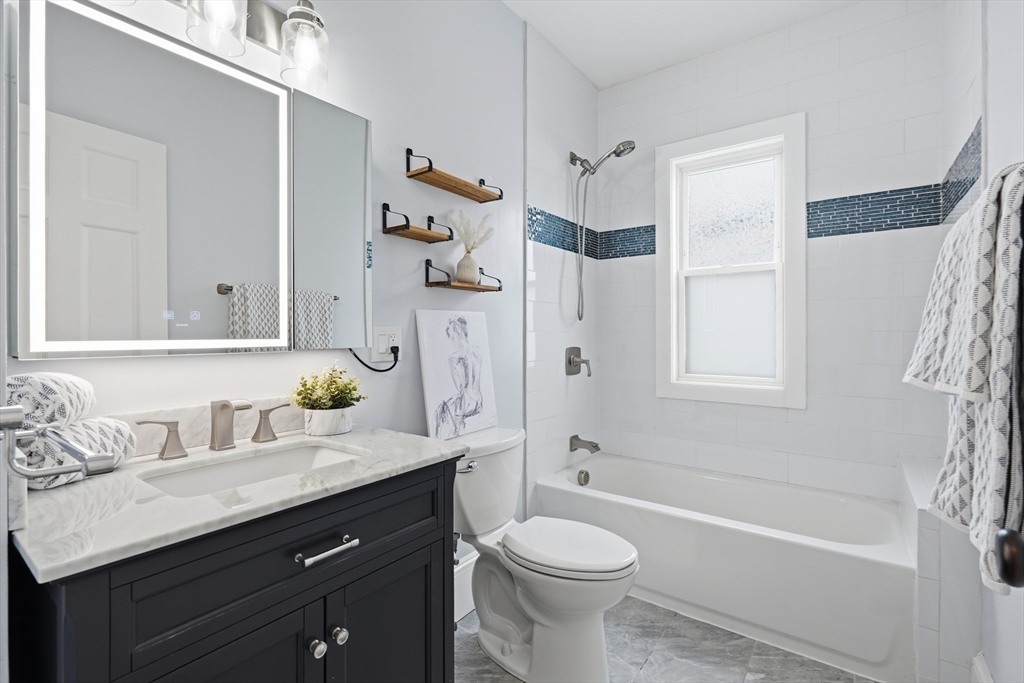 20 Ripley Road, Unit 3 Boston, MA 02121 - Photo 18 of 27 a bathroom with a granite countertop sink toilet and shower