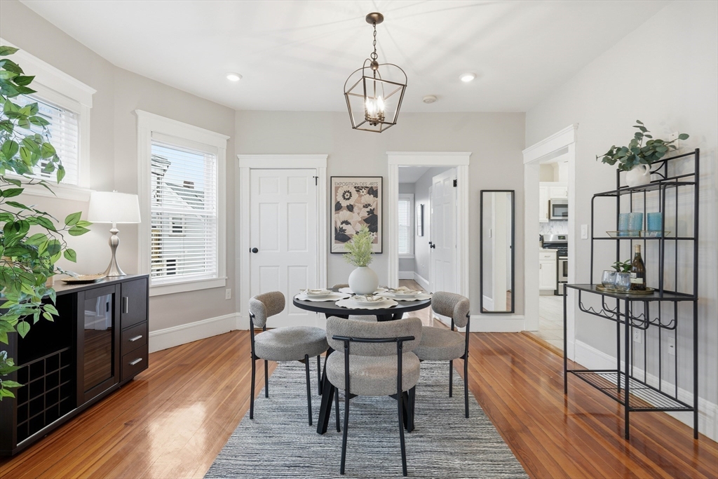 20 Ripley Road, Unit 3 Boston, MA 02121 - Photo 6 of 27 a dining room with furniture a chandelier and wooden floor