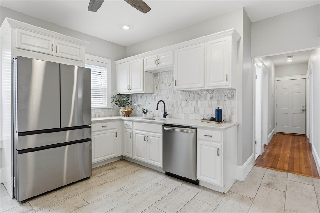 20 Ripley Road, Unit 3 Boston, MA 02121 - Photo 9 of 27 a kitchen with stainless steel appliances granite countertop a refrigerator sink and white cabinets