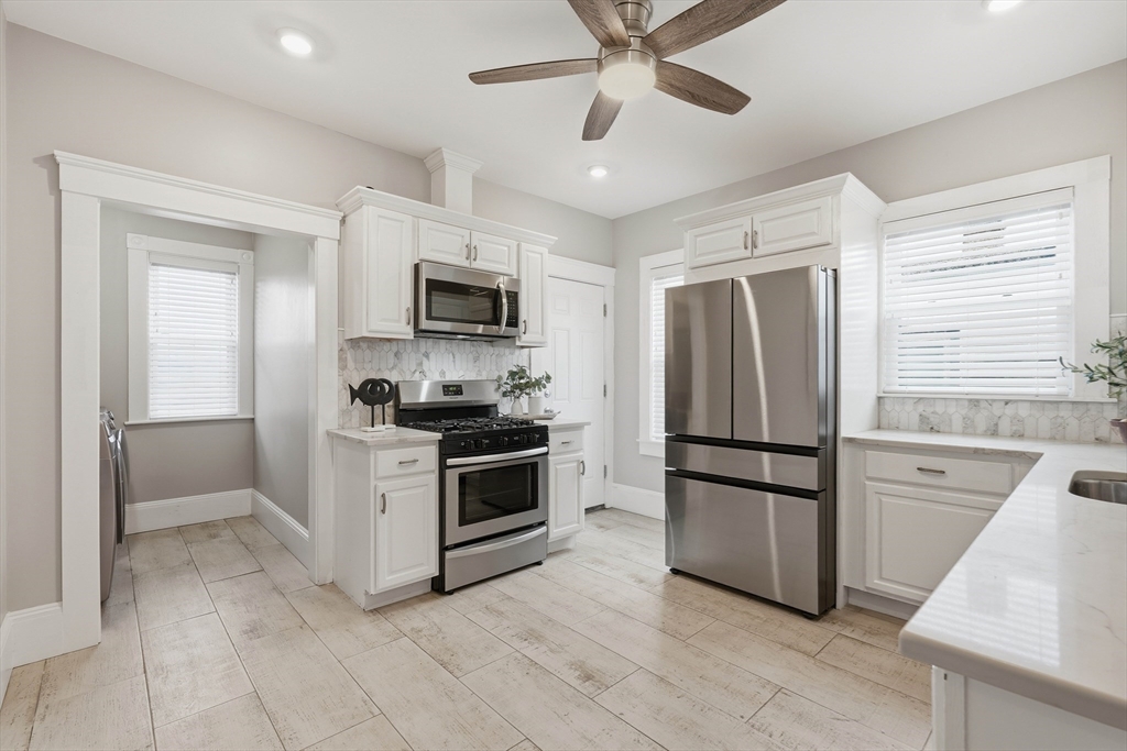 20 Ripley Road, Unit 3 Boston, MA 02121 - Photo 10 of 27 a kitchen with stainless steel appliances a refrigerator sink and microwave