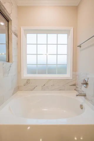 a bathroom with a bathtub and a window
